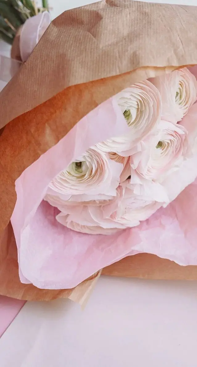 Pink ranunculus bouquet wrapped in kraft paper (illustrative photo)